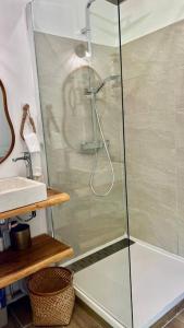 a shower with a glass door in a bathroom at Suite Caraïbes 2 - Superbe Studio Cosy Vue Mer in Les Trois-Îlets