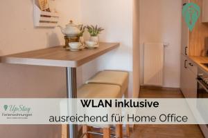 a small kitchen with a table in a room at Butzenhuuske in Krummhörn +5 photos
