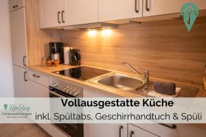 a kitchen with a sink and a counter top at Butzenhuuske in Krummhörn