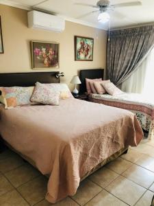a bedroom with a large bed and a window at JoThams Bed & Breakfast or Self-catering in Durban