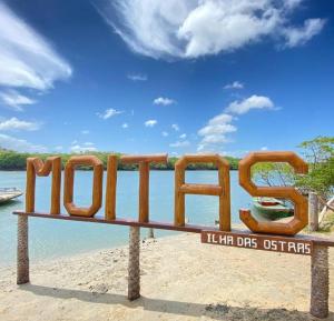 a bench with the word hilo in front of the water at Casadijaina in Amontada +7 photos