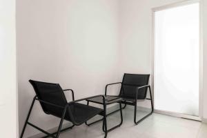 two chairs and a table in a room at Phaedrus Living: Limassol Seaside Residences 03 in Limassol