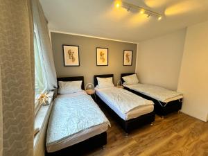 a bedroom with two beds and a window at Duisburg Flats 24 in Duisburg