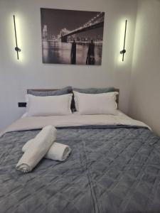 a bedroom with a large bed with a pillow on it at Уютная квартира в Бухар Жырау in Astana