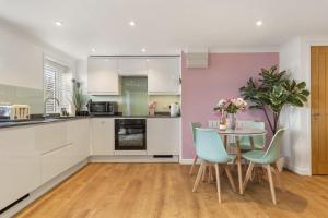a kitchen and dining room with a table and chairs at The Hidden Valley - a stylish rural retreat, perfect for families in St Clears