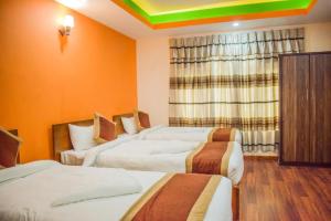 Letto o letti in una camera di Kathmandu Peace Hotel