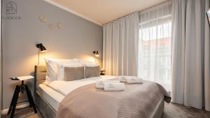 a bedroom with a bed with two towels on it at City Center SPA Apartments Jaglana 6E,F in Gdańsk