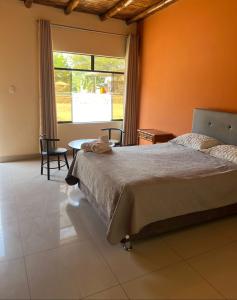 a bedroom with a bed and a table and a window at Hospedaje La Huega in Ica +73 photos