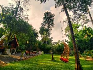 a garden with a hammock and a swing at Syara villa in Unawatuna