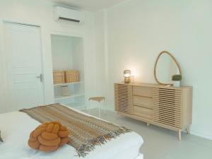 a room with a bed with a mirror and a dresser at Beachside Sunset Oasis at Canyon Cove in Nasugbu