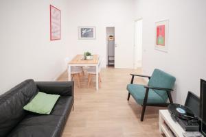 a living room with a black couch and a table at Vatican Museum Apartment in Rome