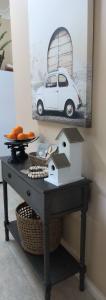 a table with a picture of a car on the wall at HUNTER COTTAGE EUROA - "A great weekend escape" in Euroa +16 photos