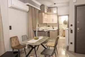 a kitchen and dining room with a table and chairs at Maybe Home suite apartments No3 in Drama