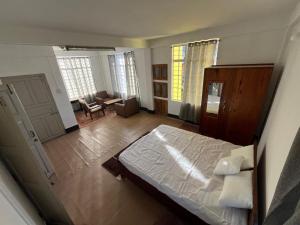 a bedroom with a bed and a living room at PuVi Homestay, Dzukou entry point in Viswema