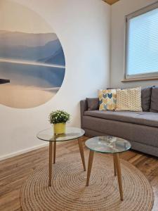 a living room with a couch and two tables at 10min zum CenterParcs, Bungalow mit Garten,Carport in Leutkirch im Allgäu +26 photos