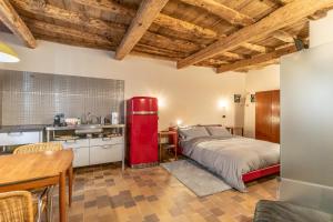 a kitchen with a red refrigerator in a room at Mina Suites in Cervia