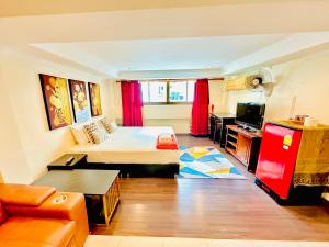 a living room with a bed and a couch at Sky Silk Decoration House in Patong Beach