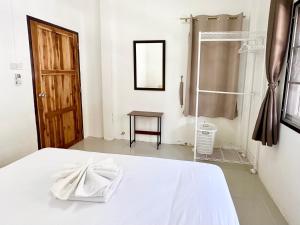 a bedroom with a white bed and a shower at Cozy 3 BR house & green lawn near Airport & Old town in Chiang Mai +87 photos