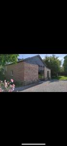two pictures of a building and a brick building at La grange de Livia in Ferrière-la-Grande