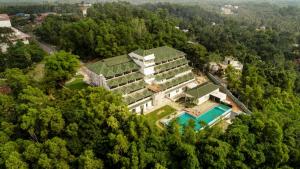 an aerial view of a building in the forest at Avoki Resorts in Trivandrum