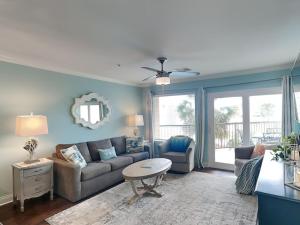 a living room with a couch and a table at Maravilla 146-sea Ya Next Tide in Galveston