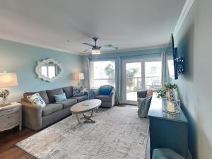 a living room with a couch and a table at Maravilla 146-sea Ya Next Tide in Galveston
