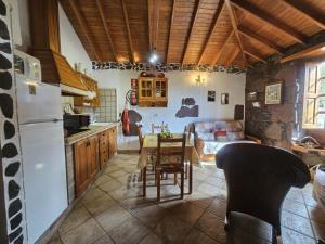 a kitchen with a white refrigerator and a table at Casa Rosiana in Santa Lucía