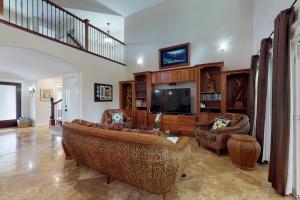 a living room with a couch and a tv at Blue Hawaii House in Princeville
