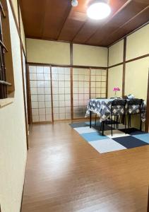 a room with a table and chairs in it at 楽宿 天下茶屋徒歩9分 最大9名様宿泊可能 一軒家貸切 in Osaka