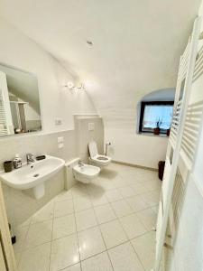 a bathroom with a sink and a toilet and a mirror at Corvina Suite in Costermano sul Garda +16 photos