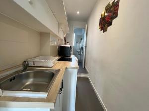 a small kitchen with a sink and a counter at Alexas's Home - Wi-Fi, Netflix in Milan