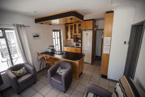 a kitchen with a table and two chairs and a counter at Chapman's Peak Bed and Breakfast in Hout Bay