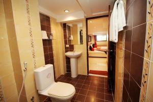 a bathroom with a toilet and a sink at Sky Silk Decoration House in Patong Beach +100 photos