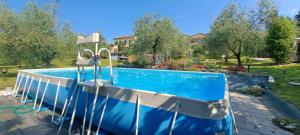 a large blue swimming pool in a yard at Ai Bastiani in Capannori