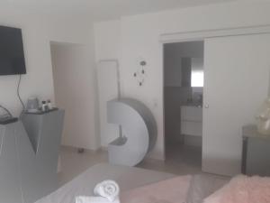 a white bathroom with a large number on the wall at Love Room Glamour in Tremblay-En-France