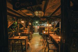 a restaurant with tables and chairs and a bar at Poleo in Arusí +89 photos