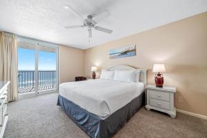 a bedroom with a bed and a large window at Romar Tower Unit 8C in Orange Beach