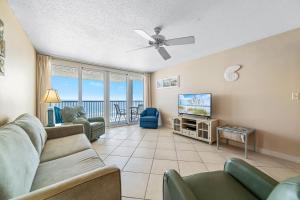a living room with a couch and a flat screen tv at Romar Tower Unit 8C in Orange Beach