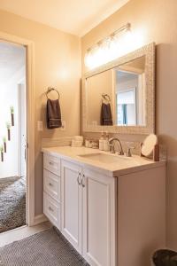 a bathroom with a sink and a mirror at Cozy Family Home with Hot Tub and Workspace Near Portland in Vancouver +35 photos