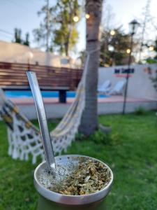 a bowl of food with a spoon in it at Cabañas Apart del Sauce II in Paraná