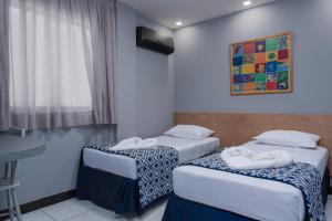 Postel nebo postele na pokoji v ubytování Ritz Praia Hotel
