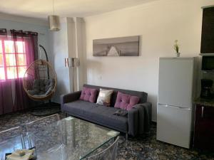 a living room with a couch and a glass table at Vacacional Tegueste 1ºA in Vecindario