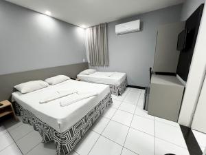 Postel nebo postele na pokoji v ubytování Ritz Praia Hotel