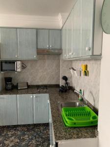 a kitchen with a green tray on a sink at Vacacional Tegueste 2ºA in Vecindario +8 photos