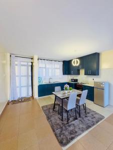 a kitchen and dining room with a table and chairs at Chill Spot in Nakuru
