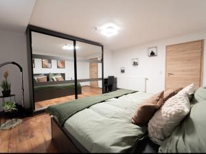a bedroom with a large bed and a large mirror at Ferienwohnung Sunny in Schmallenberg