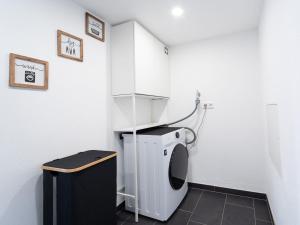 a small bathroom with a washing machine in a room at Ferienwohnung Sunny in Schmallenberg +2 photos
