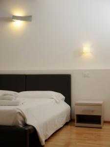 Postel nebo postele na pokoji v ubytování Hotel Arezzo ASC