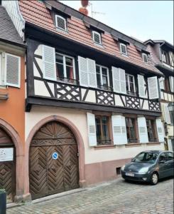 a car parked in front of a building with a garage at Les appartements hyper centre Barr in Barr +25 photos