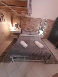 a hospital bed with two pillows in a room at Minimal Studio. in Kavala